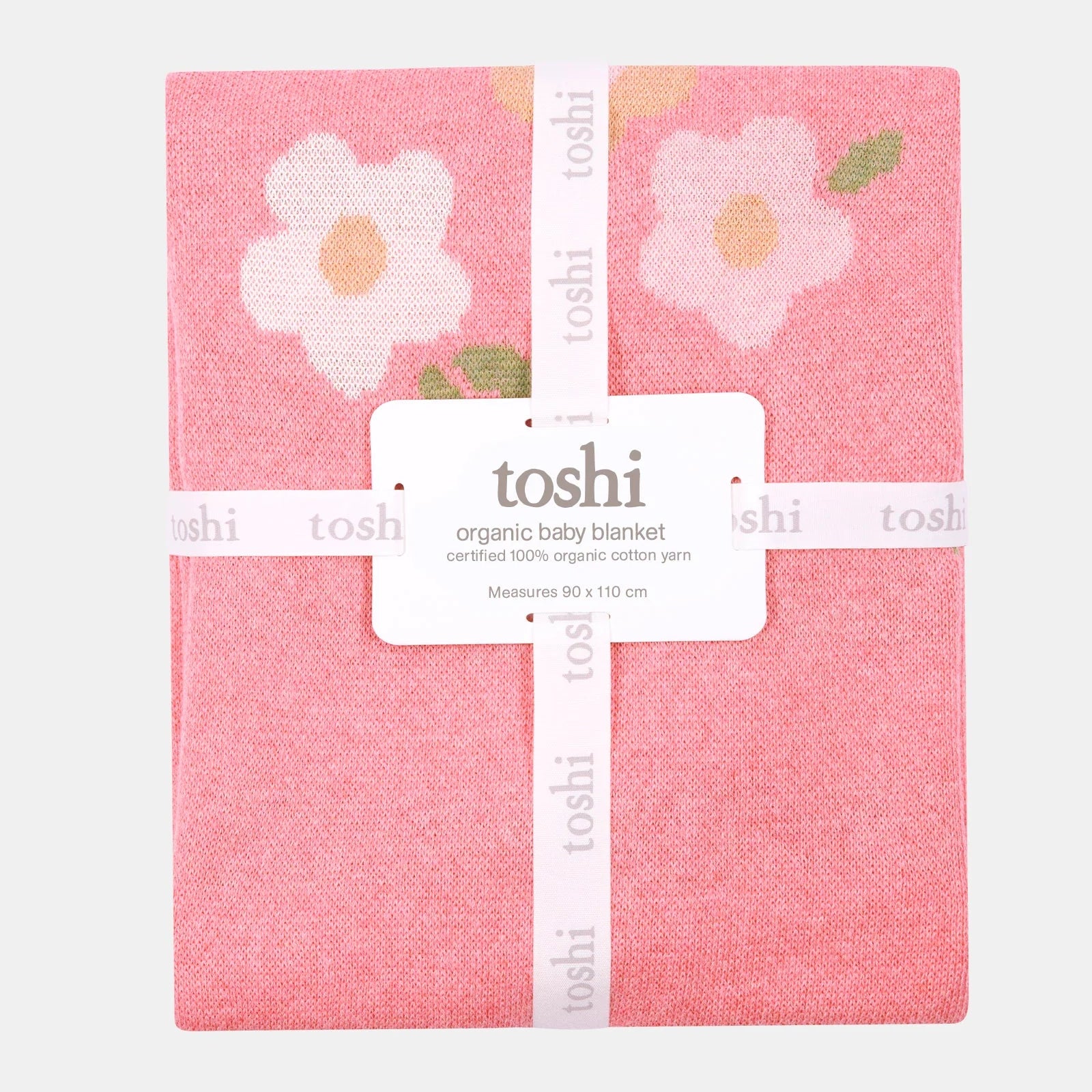 Pink baby blanket with floral design and 'toshi' branding on a white background