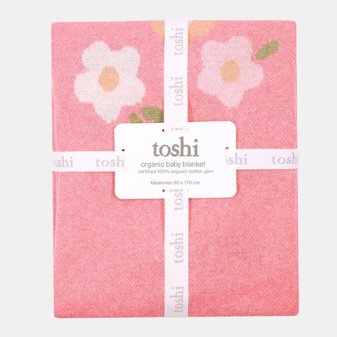 Pink baby blanket with floral design and 'toshi' branding on a white background